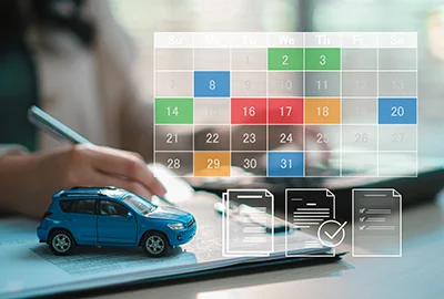Blue model car beside a calendar and checklist icons